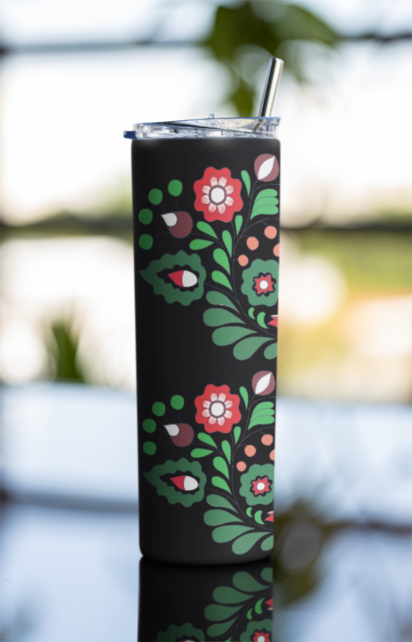 Tumbler with floral design on a black background