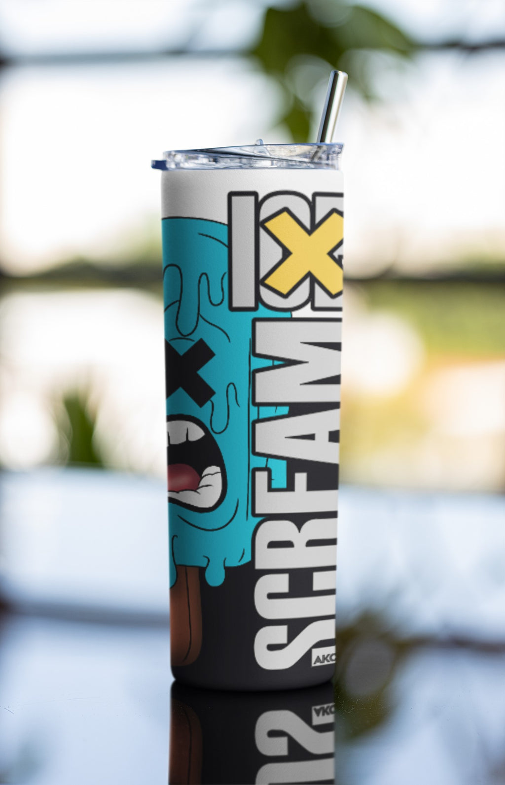 Tumbler with 'Screamix' branding against a blurred natural background