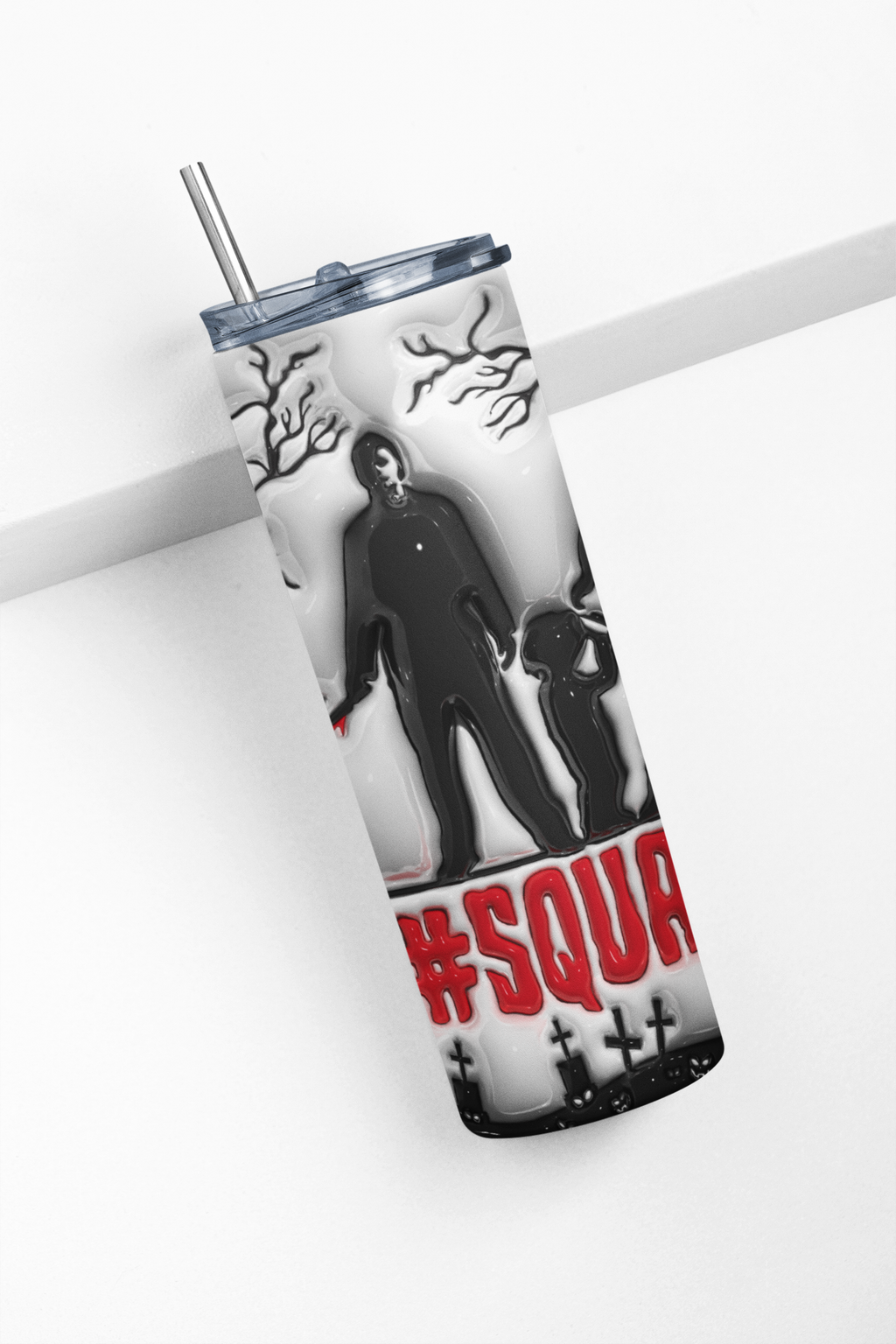 A clear insulated tumbler with a metal straw, featuring a Halloween-style graphic of a dark figure and child, black tree branches, and red text reading '#SQUA' on a white background.