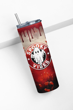 A stainless steel tumbler with a clear lid and metal straw, featuring a Halloween-themed wrap design with a red and black blood-splatter gradient, dripping effect, and a central circular logo that reads 'Spooky Vibes' with a white ghost.