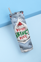 A stainless steel tumbler with a clear lid and metal straw, featuring a festive holiday design of a white reindeer wearing a Santa hat and the text 'Merry GRINCH mas' in red and green lettering, set against a light blue background.
