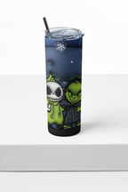 A tall insulated tumbler with a clear lid and black straw, featuring a printed design of Jack Skellington and the Grinch in green and black tones against a dark blue night sky, displayed on a white surface.