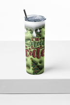 A tall insulated tumbler with a clear lid and black straw, featuring a green holiday design with dripping white frosting, red script text reading 'I'M Snow cute', and a small Christmas tree illustration, shown on a white surface against a white background.
