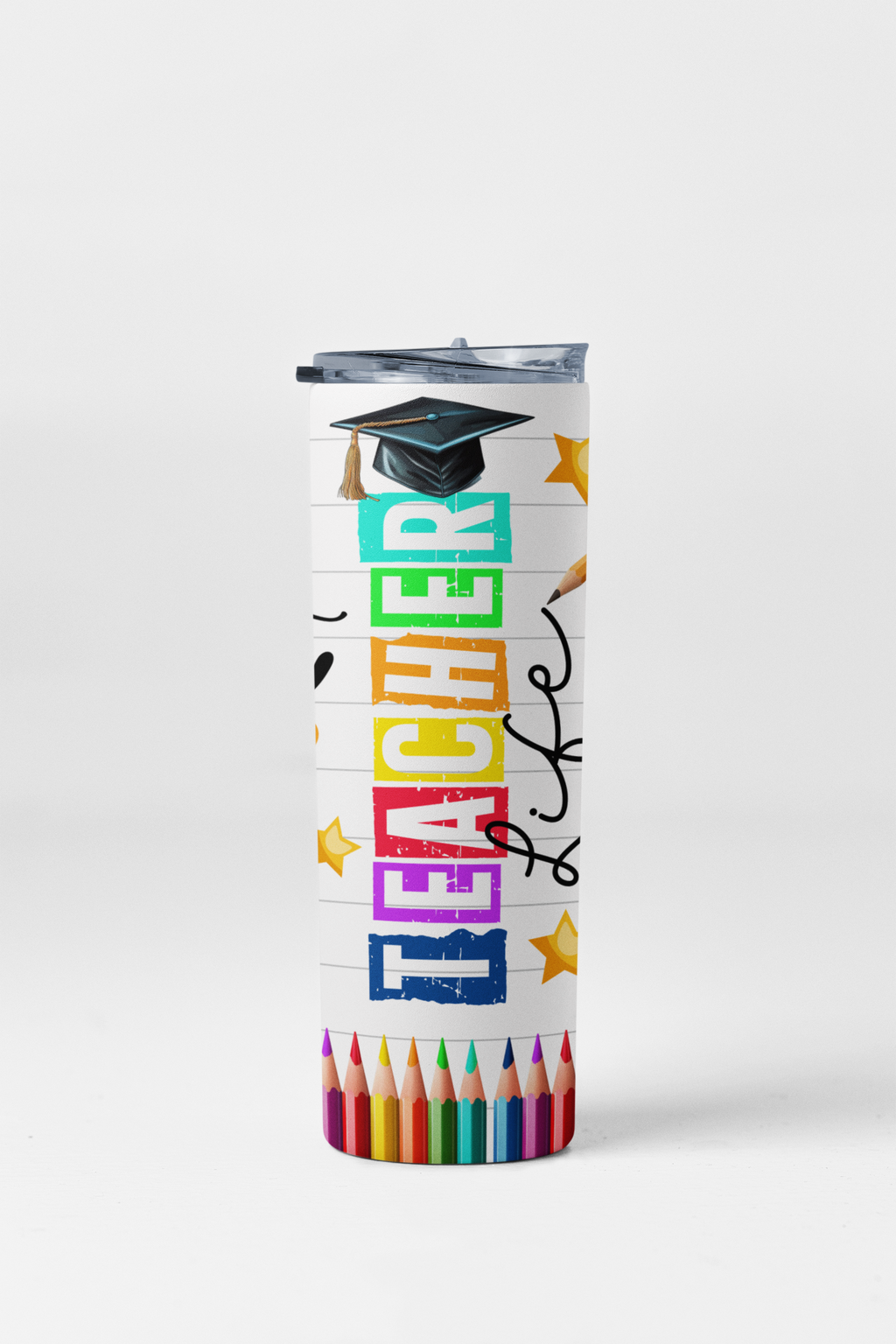 Tumbler with colorful text 'Teacher Life' and a graduation cap, surrounded by colored pencils on a white background.