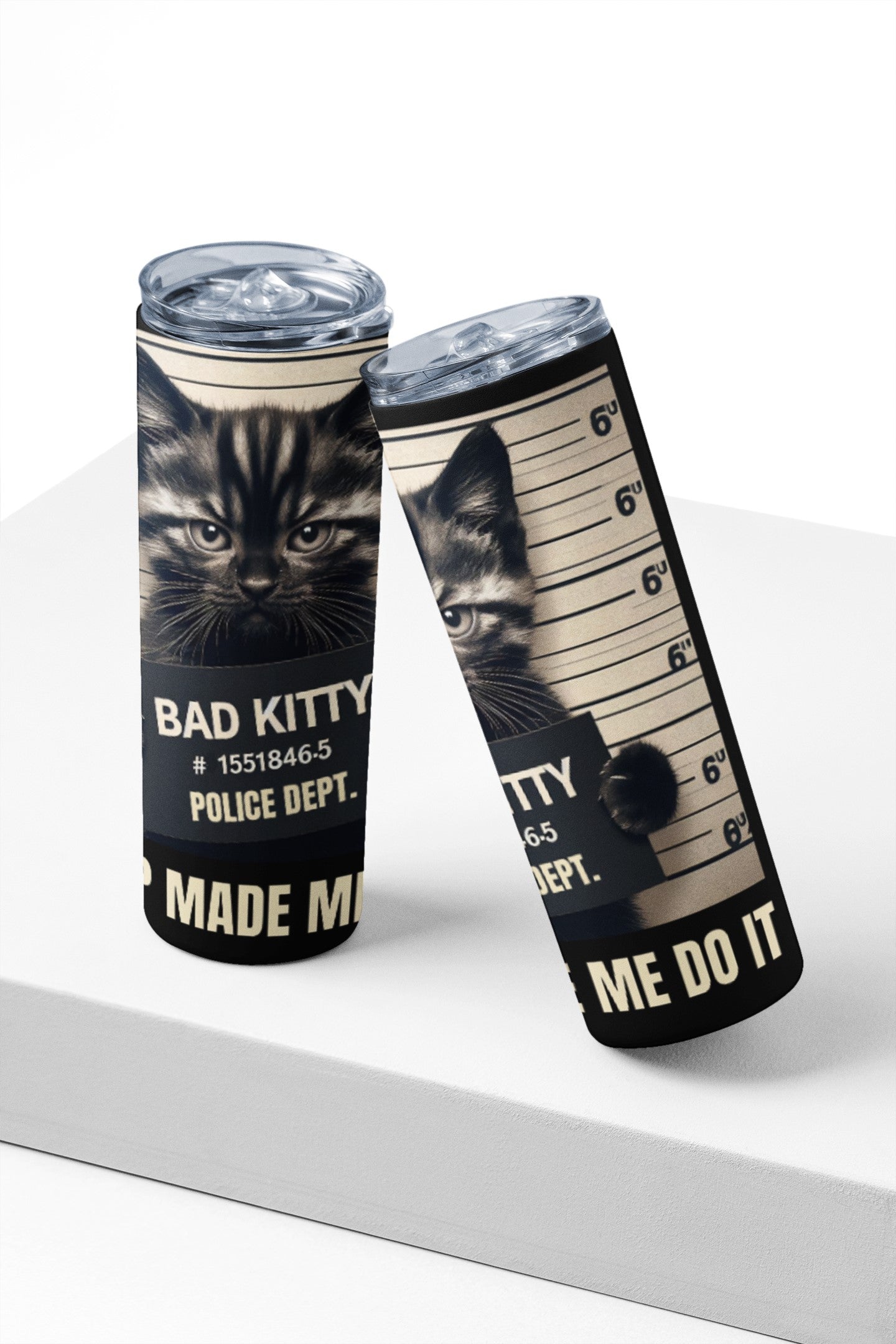 Two tumblers with a cat-themed design on a white surface