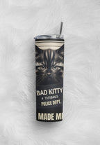 Tumbler with a cat design and text on a textured white background