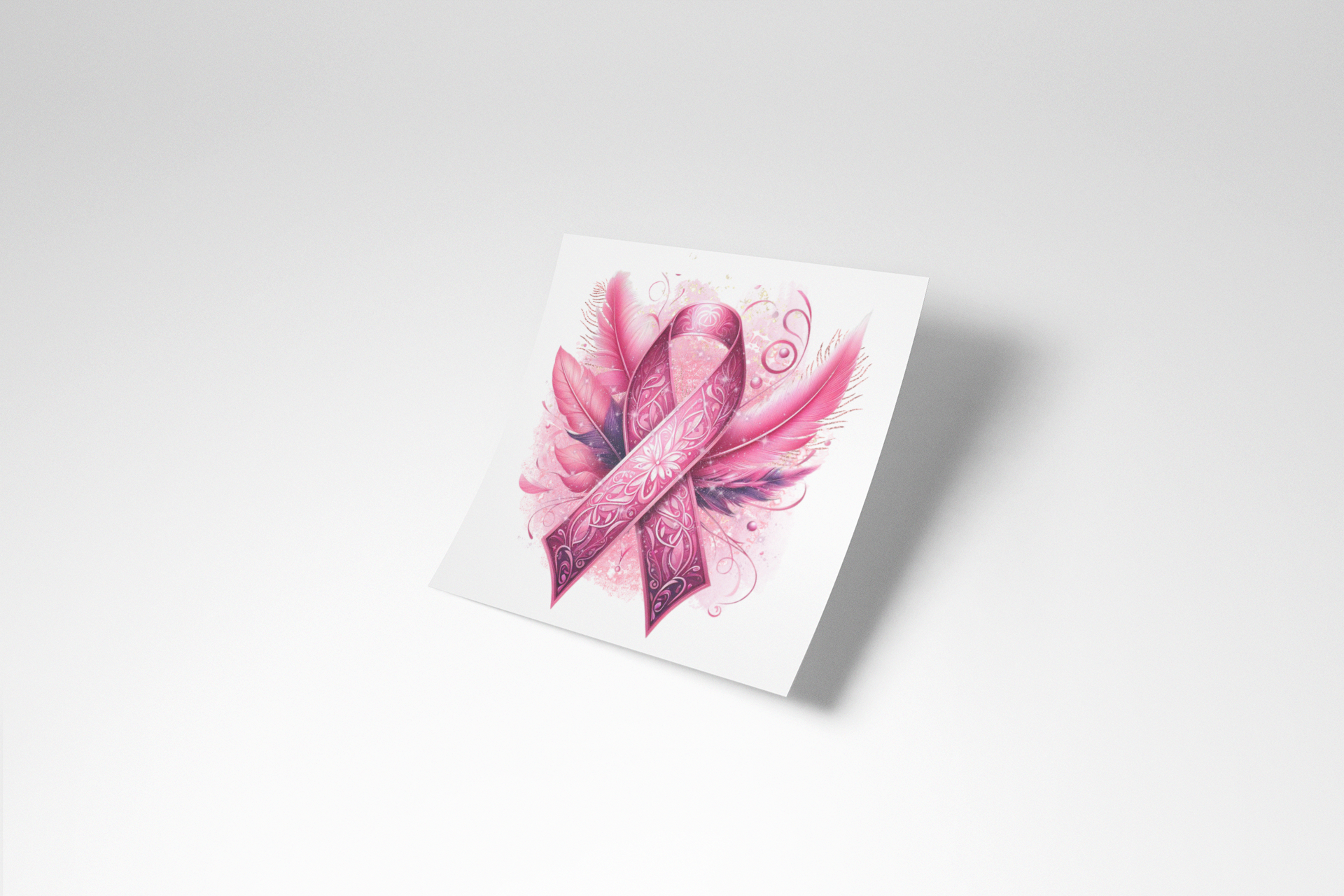 Pink ribbon with floral design on a white card