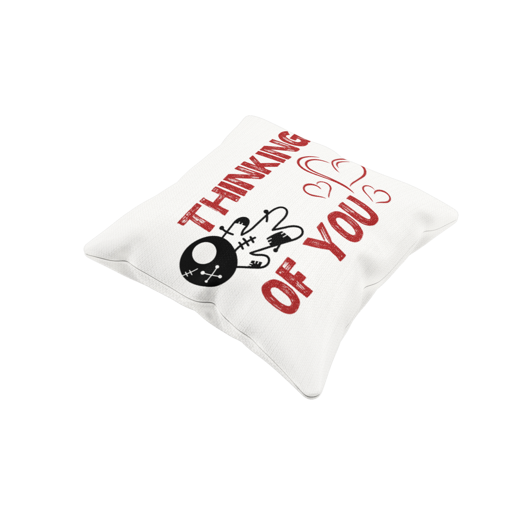 White pillow with red text 'I'm thinking of you' and a black skull design on a white background