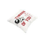 White pillow with red text 'I'm thinking of you' and a black skull design on a white background