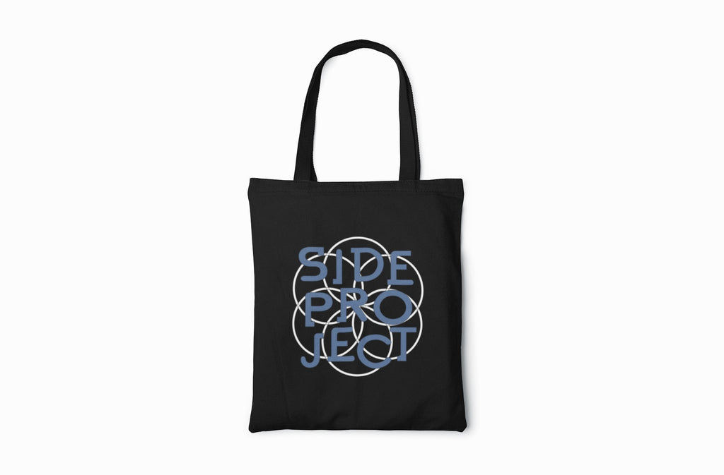 Black tote bag with blue circular design on a white background