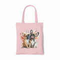 Pink tote bag with two puppies and floral designs on a white background