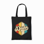 Black tote bag with 'Dada' graphic design on a white background