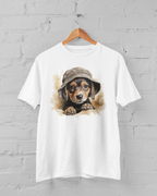 White t-shirt with a dog wearing a hat graphic on a hanger against a gray brick wall.