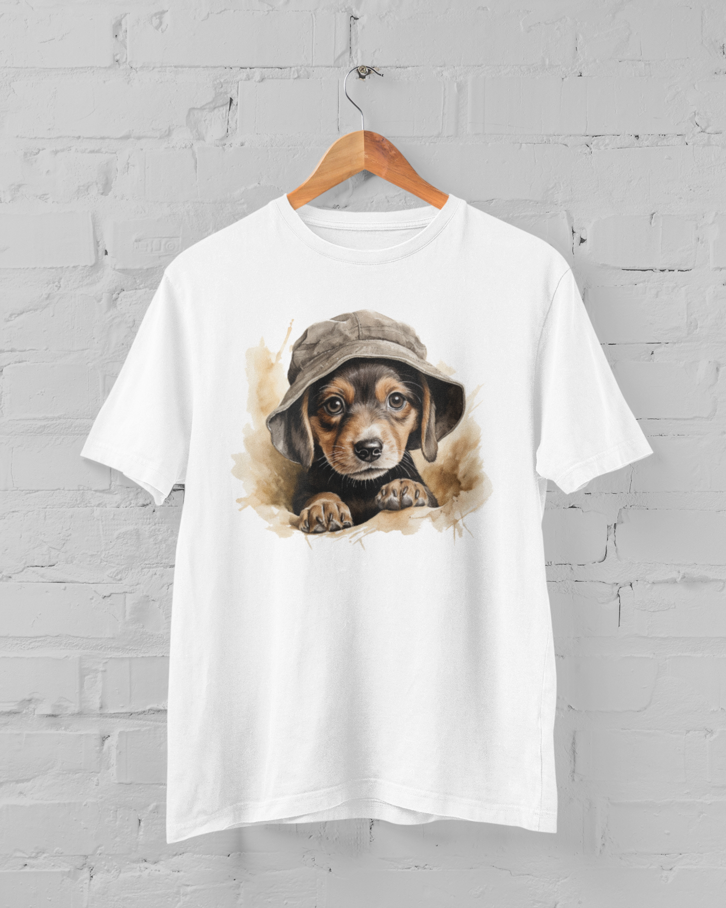White t-shirt with a dog wearing a hat graphic on a hanger against a gray brick wall.