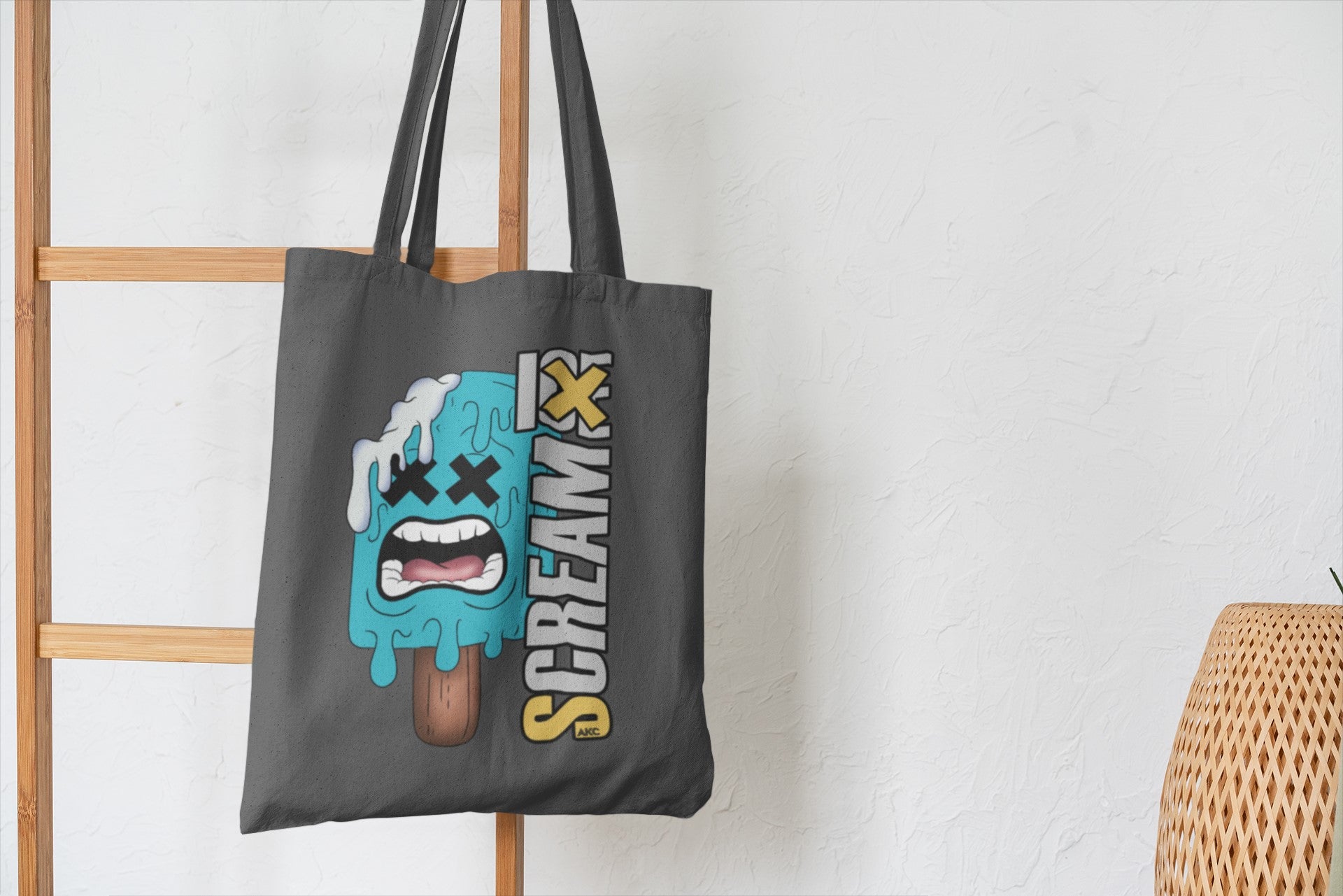 Tote bag with a graphic design on a wooden ladder against a white wall