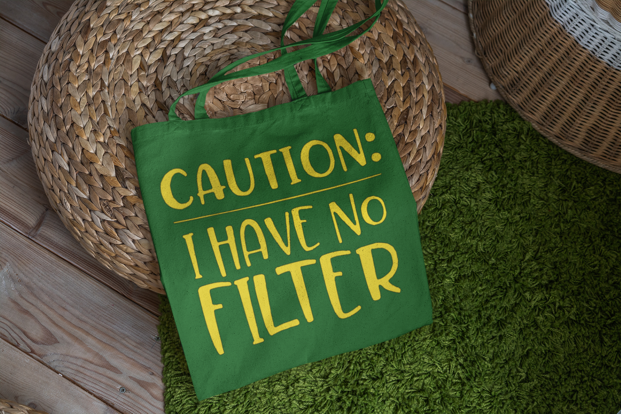 Green tote bag with 'CAUTION: I HAVE NO FILTER' text on a green surface.