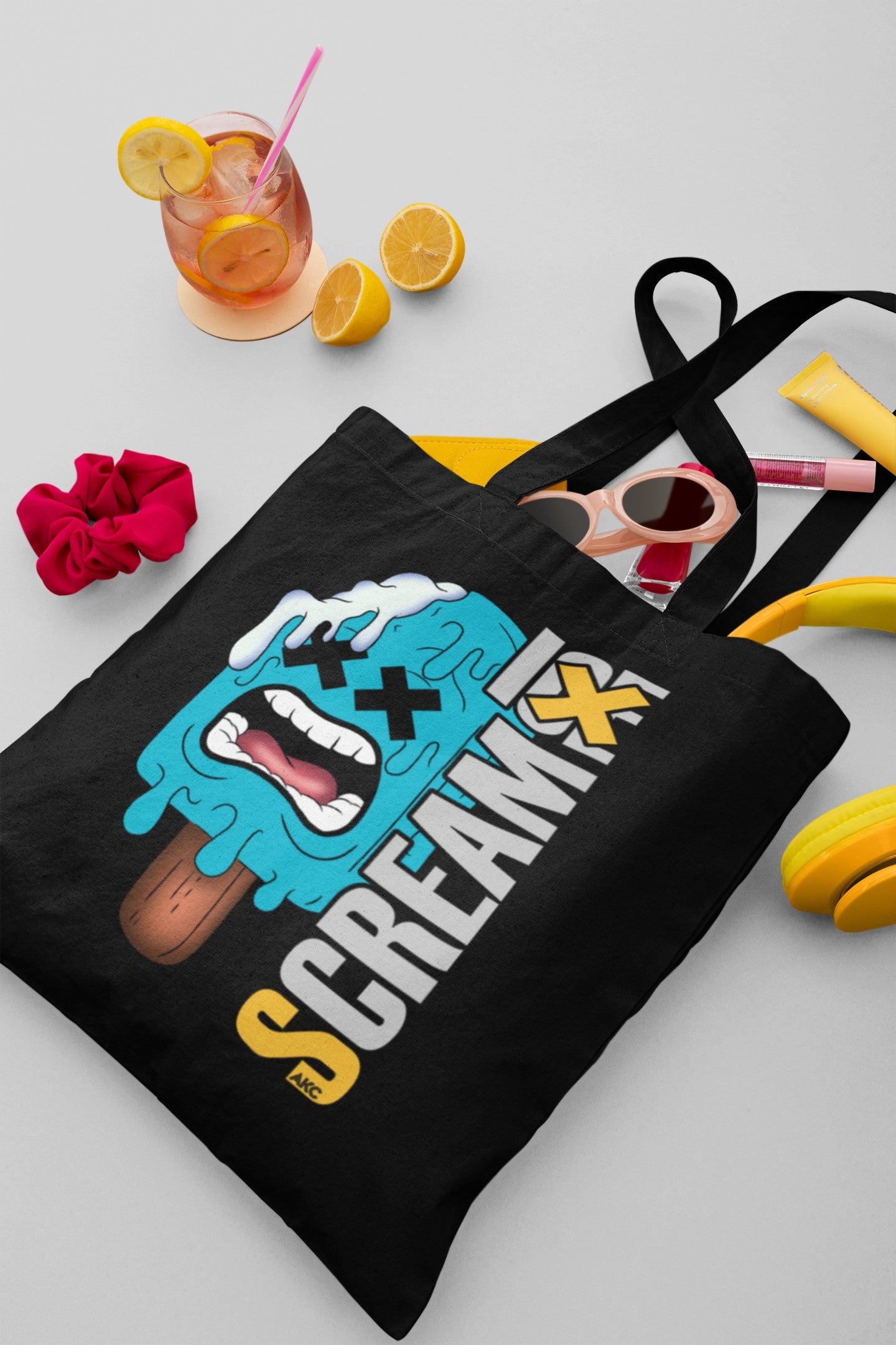 Black tote bag with ice cream graphic and 'Scream' text on a light gray background