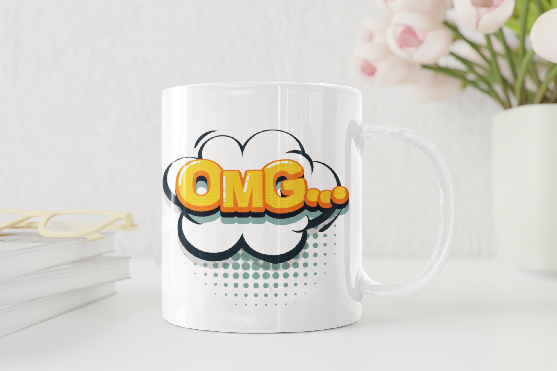 White mug with 'OMG' design on a white surface with flowers in the background
