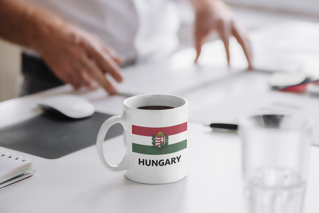 White mug with 'Too Many Tabs Open' text on a desk with a blurred background