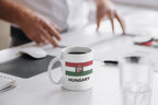 White mug with 'Too Many Tabs Open' text on a desk with a blurred background