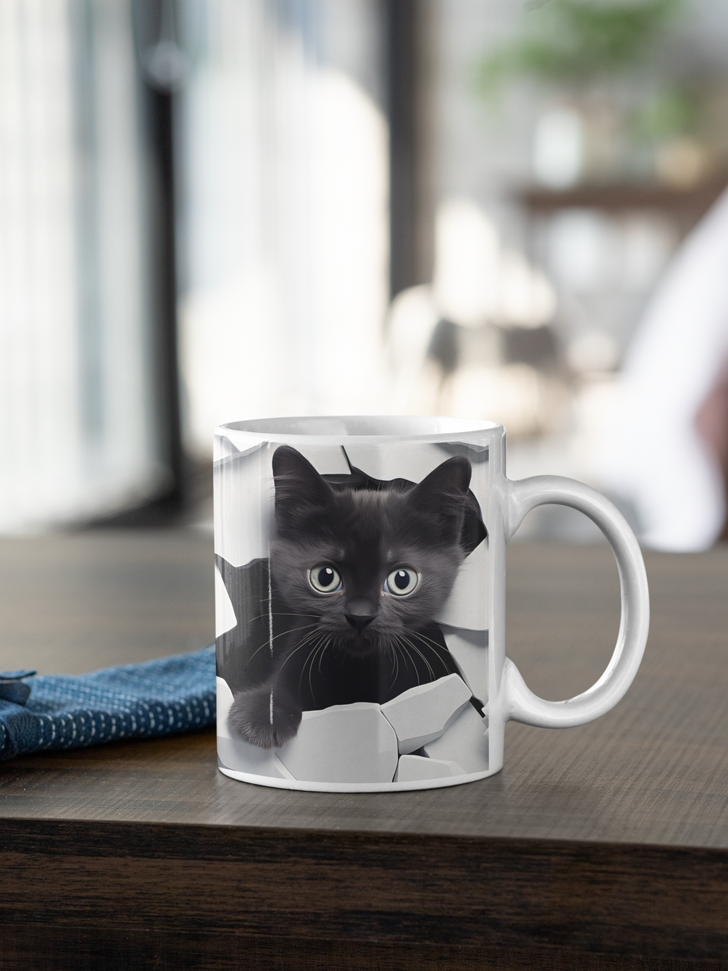 Mug with a black cat design on a wooden surface