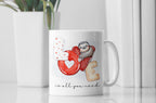 Mug with a sloth design and 'LOVE is all you need' text on a white surface.