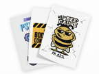 Three overlapping white art prints or cards on a black background. The front card shows a cartoon bee wearing sunglasses with the text 'WHY U BEE-CAUSE I'M COOL'.