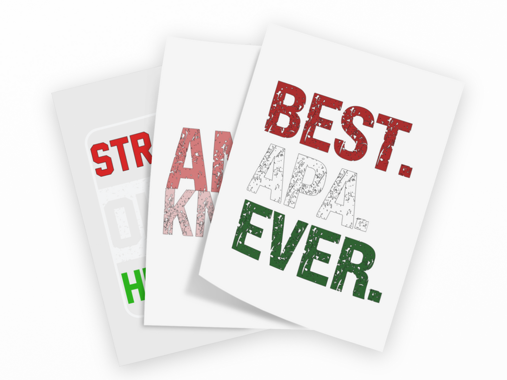 Three white greeting cards fanned out on a black background, each printed with bold distressed text. The front card reads 'BEST.