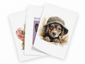 Three overlapping greeting cards on a white background, each featuring a different cute animal illustration: a dachshund puppy wearing a hat, a hamster, and a cat with the word 'HUG' partially visible.