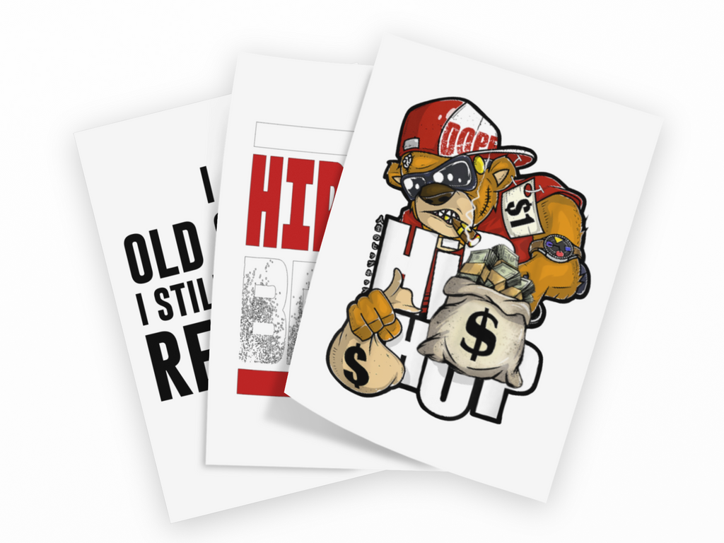 Three overlapping white art prints or cards on a black background, each featuring bold graphic designs: a bear in a red cap holding a money sack with a dollar sign, a red and white HI graphic, and black text reading 'OLD I STILL RE'.