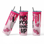 Three views of a pink and white drip-style tumbler with black text reading 'NO YOU HANG UP' and pink heart graphics, shown on a clean white background.