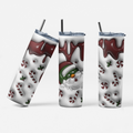 Three views of a stainless steel tumbler with a Christmas-themed wrap design, featuring a Santa Claus face, candy canes, holly, and dripping dark red chocolate on a white background, with clear lids and black straws.