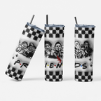 Three views of a tall insulated tumbler with a clear lid and metal straw, printed with a black-and-white checkerboard pattern, horror character artwork, and the word "FRIENDS" in the classic red, yellow, and blue dot style on a light gray background.