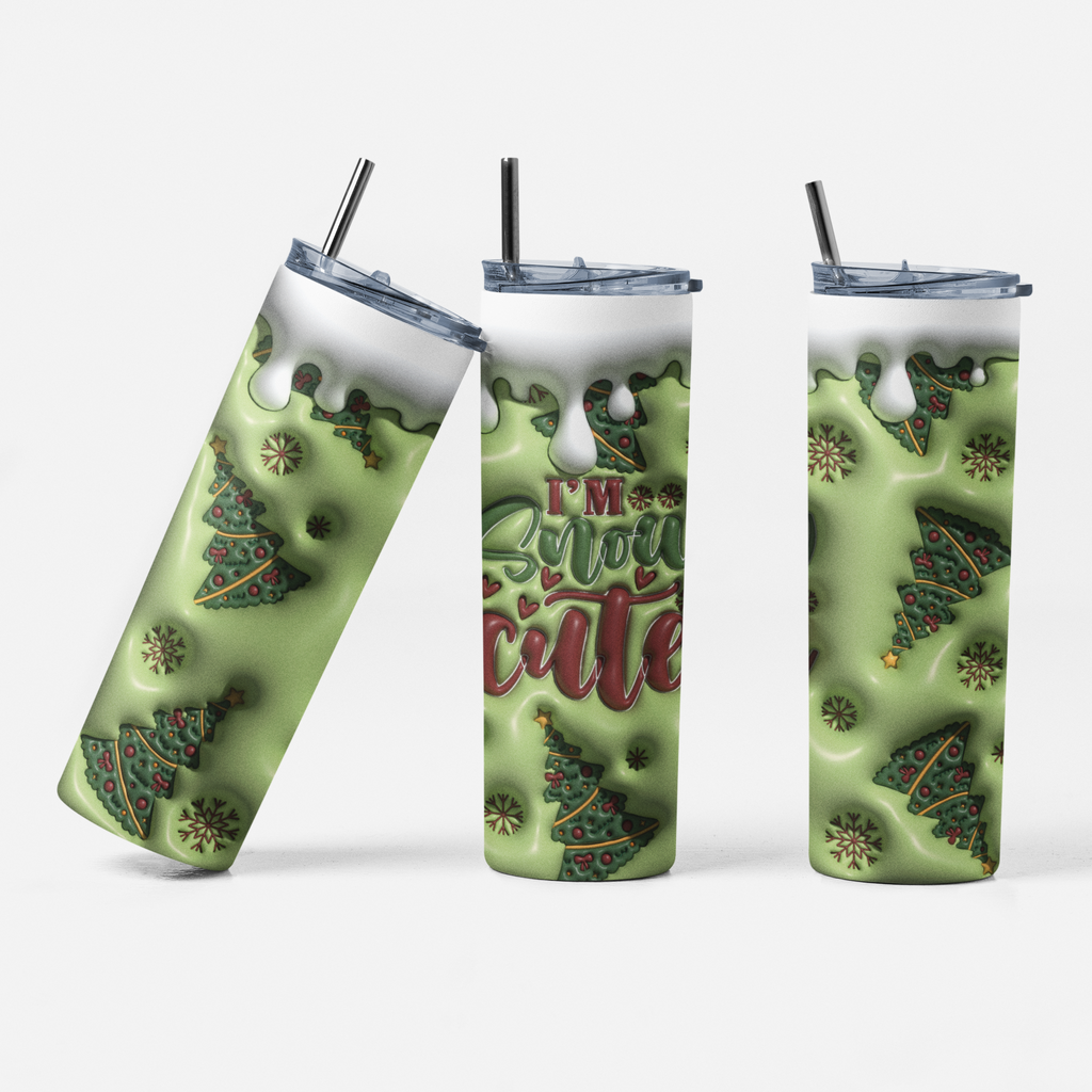 Three views of a tall insulated tumbler with a clear lid and black straw, printed with a light green holiday design featuring Christmas trees, snowflakes, and the phrase “I’m Christmas cute.”.