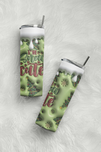 Two slim stainless steel tumbler cups with clear lids and metal straws, shown on a white faux-fur surface. The cups have a light green holiday-themed design with dripping white faux snow, gold snowflake details, and the text 'I'M so snow cute' in green and red lettering.