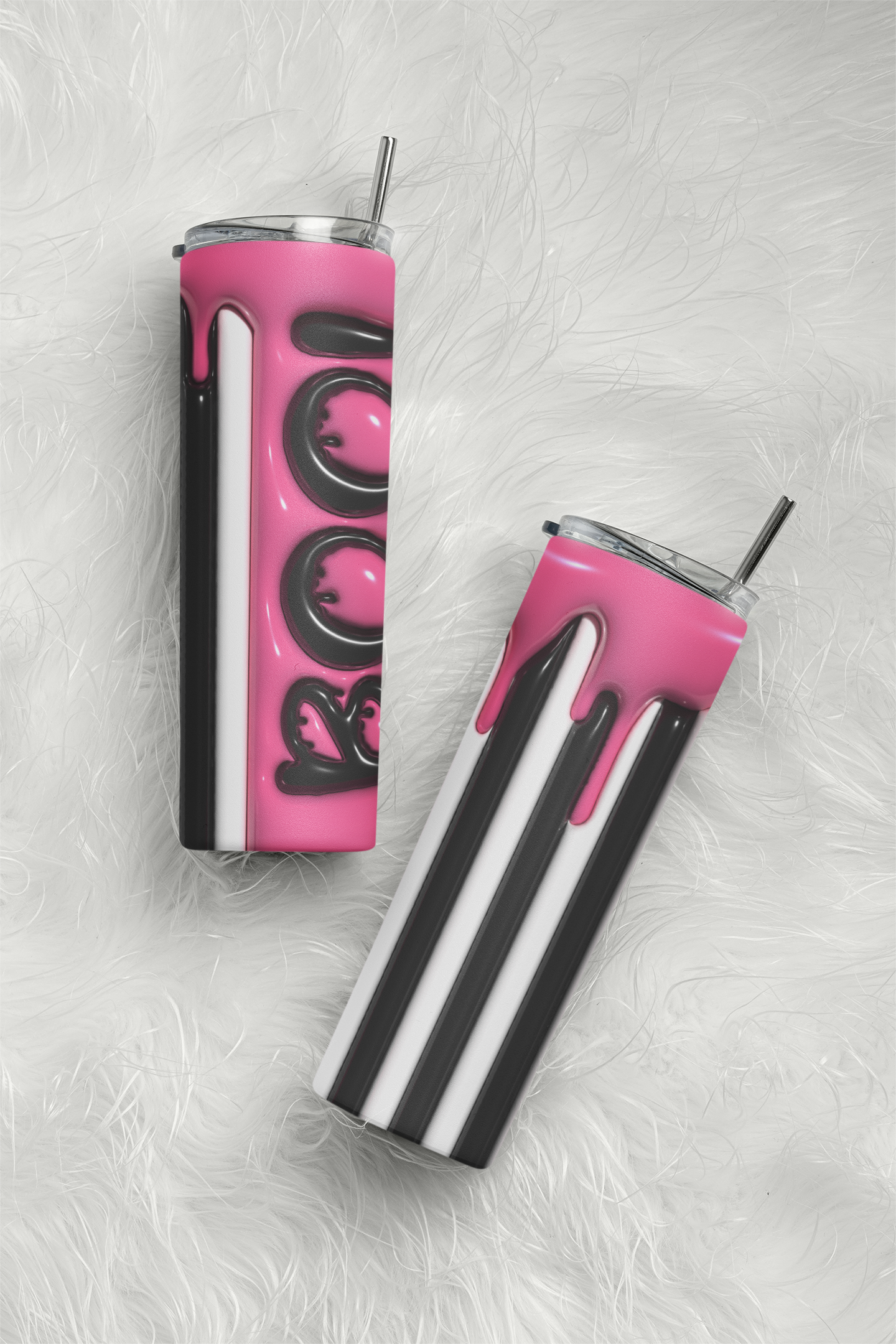 Two insulated stainless steel tumblers with clear lids and metal straws, displayed on a white faux-fur surface. One tumbler is shown from the side with a pink and black drip design and the word 'LOVE' in black script, while the other is shown from the top with black-and-white diagonal stripes and a pink drip accent.