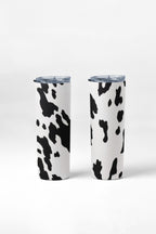 Two tumblers with cow print design on a white background