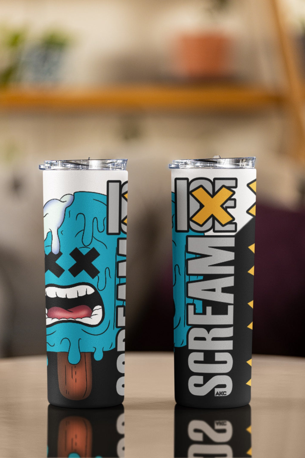 Two tumbler cups with a colorful design and 'ScreamX' branding on a blurred background.