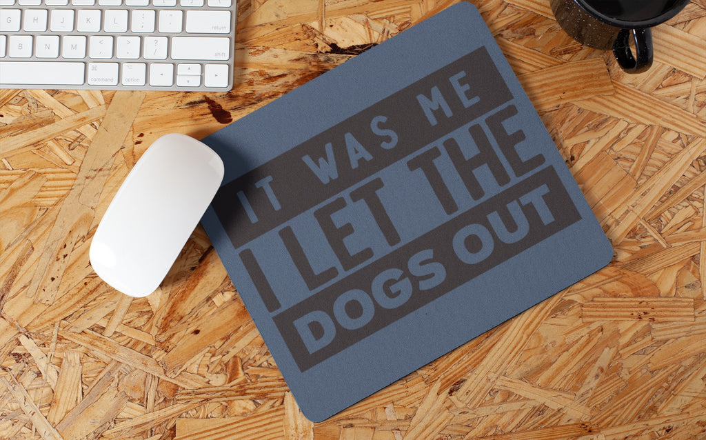 Mouse pad with humorous text on a wooden desk with a keyboard and mouse.