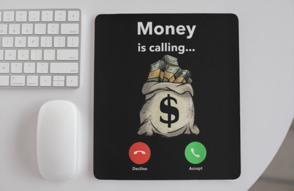Mouse pad with money-themed design and keyboard on a desk