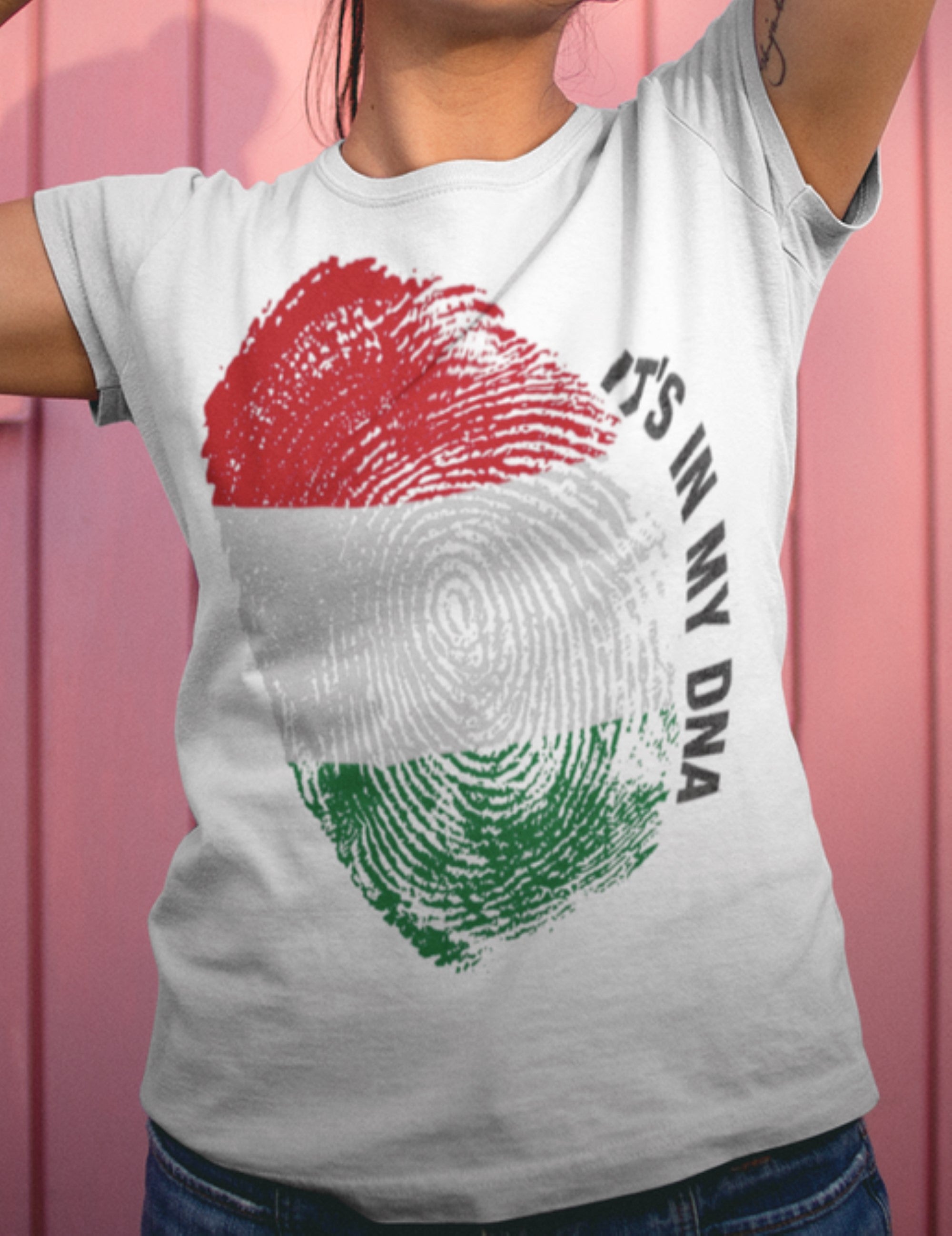 Person wearing a white t-shirt with a fingerprint design and text 'It's in my DNA' on a pink background