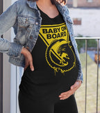 Person wearing a black t-shirt with 'Baby on Board' graphic, standing outdoors.