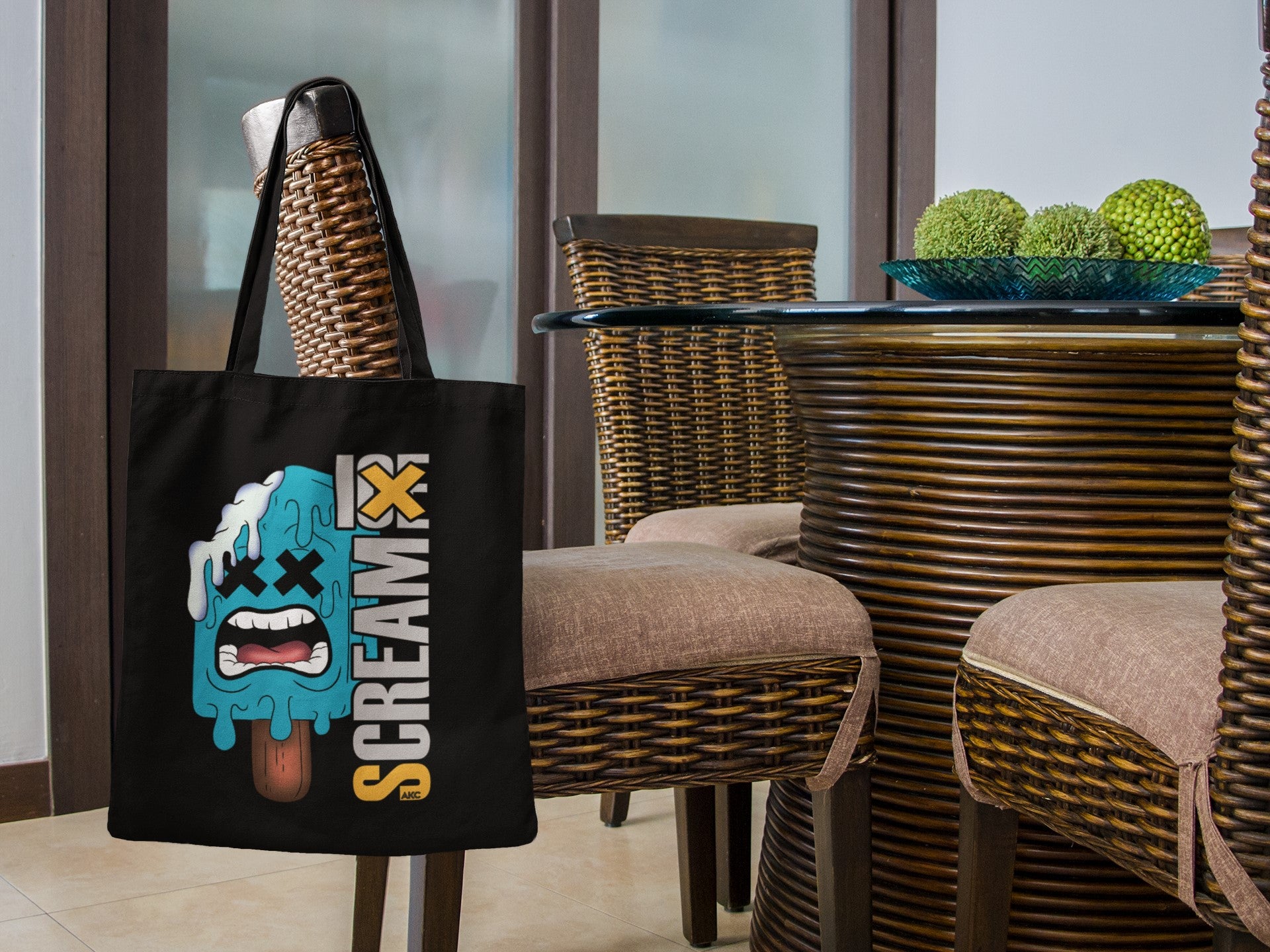 Black tote bag with a colorful graphic design on a chair in an outdoor setting