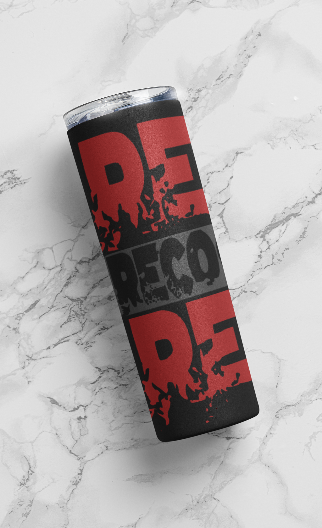 Tumbler with red and black text on a marble surface