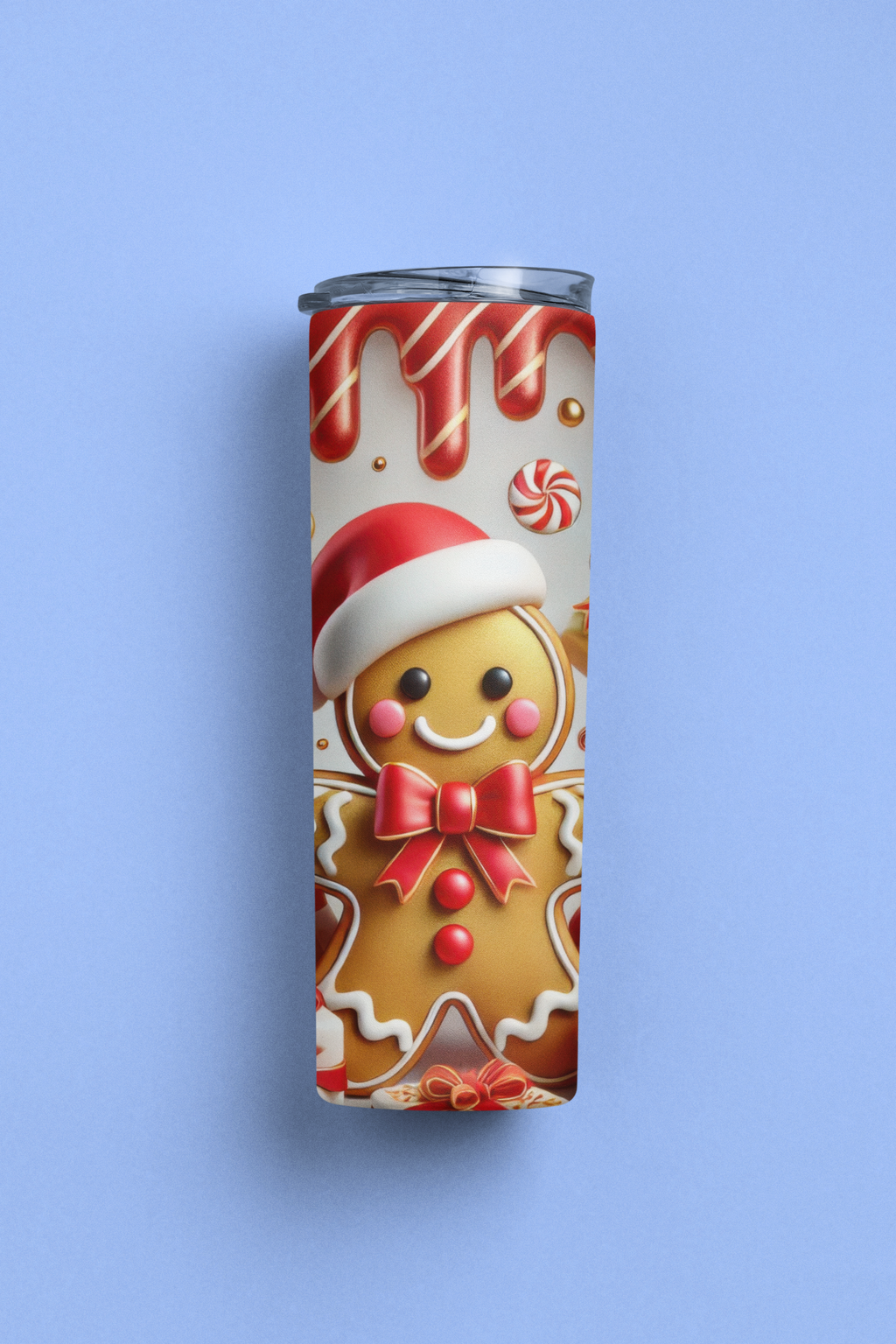 A slim stainless steel tumbler with a clear lid, featuring a festive Christmas gingerbread man print, set against a solid light blue background.
