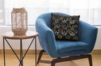 Blue armchair with a decorative pillow next to a side table with a woven lamp.