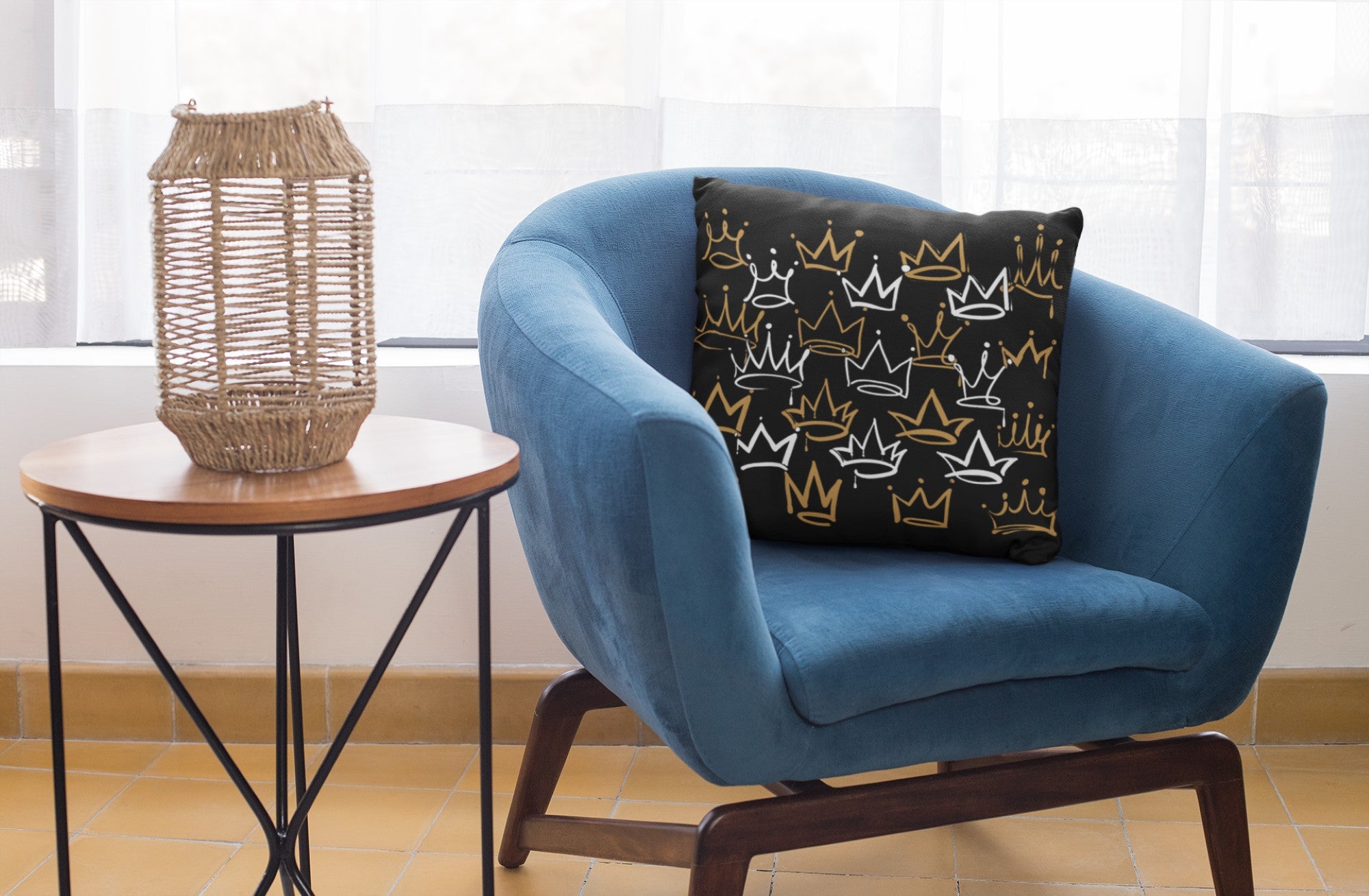 Blue armchair with a decorative pillow next to a side table with a woven lamp.