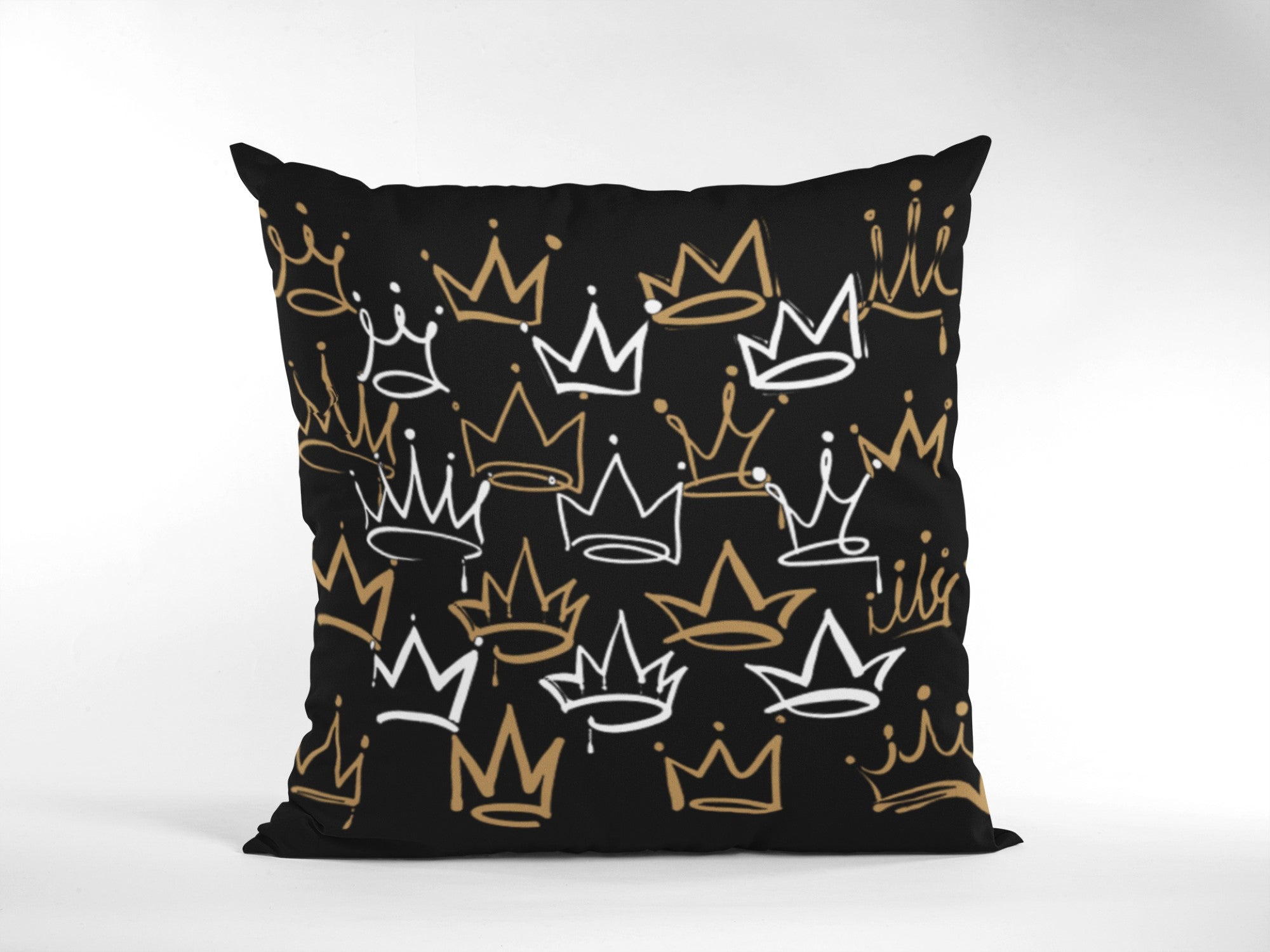 Black pillow with gold and white crown pattern on a white background