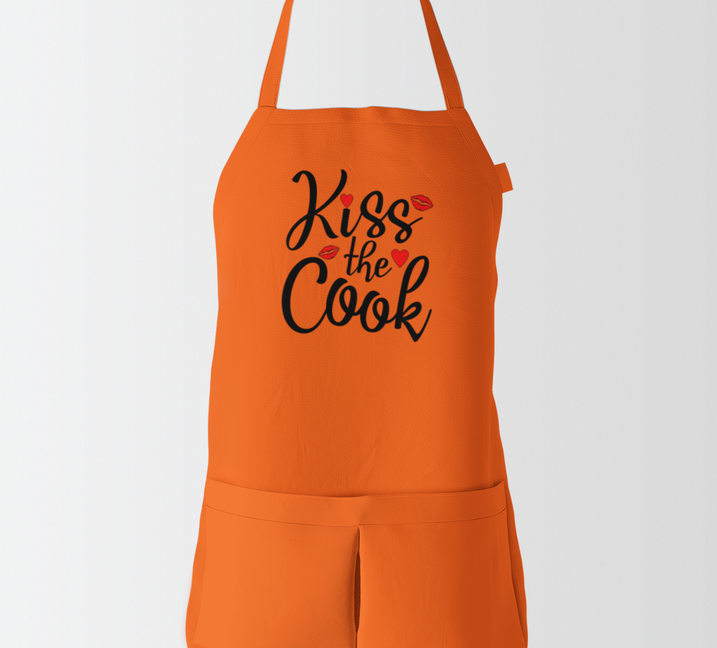 Orange apron with 'Kiss the Cook' text on a white background