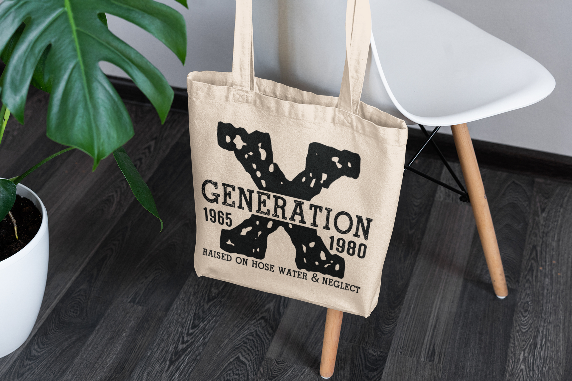Beige tote bag with 'Generation 1985' text on a wooden floor.